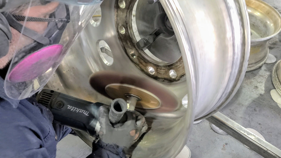 Dry sanding pits from the water channel of an aluminum drive semi-truck rim.