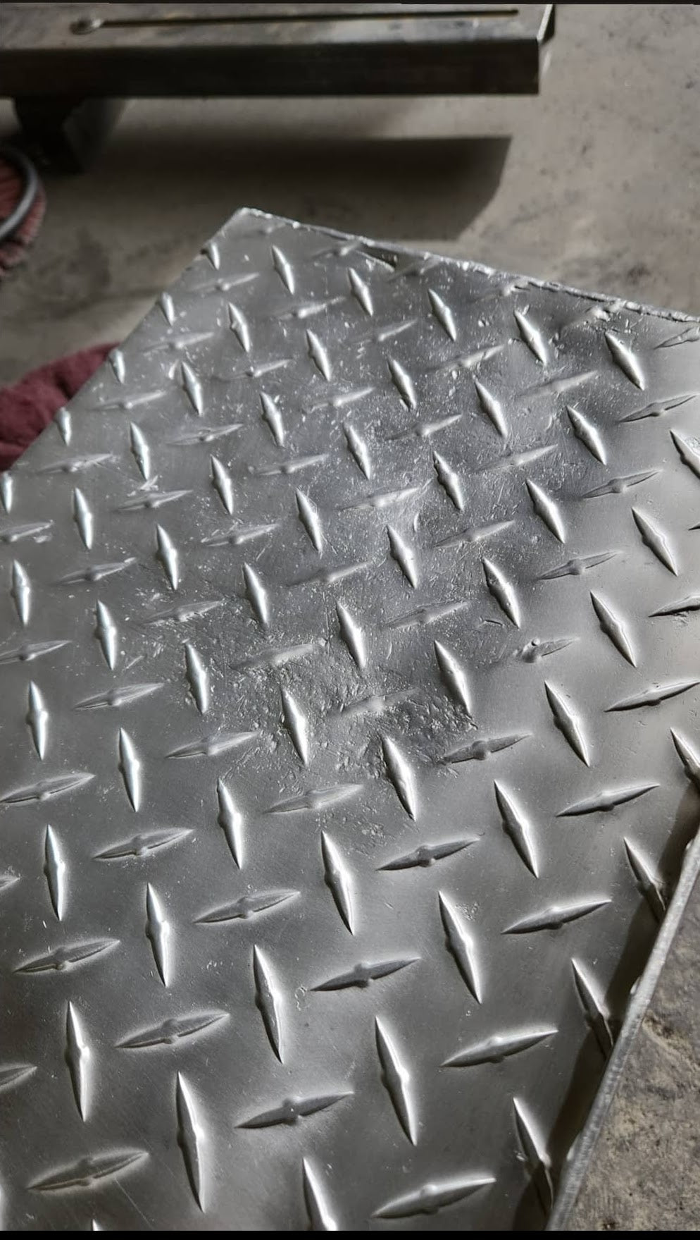Pitted diamond plate cleaned up with a dry string ring sanding buff.